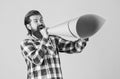 mature handsome man in checkered shirt speak in paper loudspeaker, ad