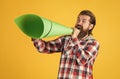 mature handsome man in checkered shirt speak in paper loudspeaker, ad