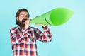 mature handsome man in checkered shirt speak in paper loudspeaker, advertisement