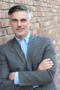 Mature handsome man smiling with arms crossed Royalty Free Stock Photo