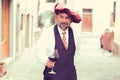 Portrait of a mature happy man with glass of red wine outdoors in old italian village Royalty Free Stock Photo