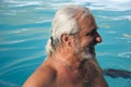 Mature happy man swimming in pool. Summer vacation and retirement. Mature man at spa resort in summer Royalty Free Stock Photo