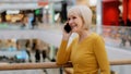 Mature happy woman speaks friendly on phone answers call communicates with family using smartphone joyful middle-aged Royalty Free Stock Photo