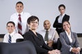 Mature Hispanic businesswoman leading office group