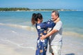 Hispanic couple calm and relax hugging each other standing at the beach during summer Royalty Free Stock Photo