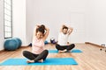 Mature hispanic couple doing excersice and stretching at yoga room Royalty Free Stock Photo