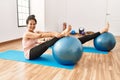 Mature hispanic couple doing excersice and stretching at yoga room Royalty Free Stock Photo