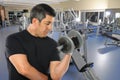 Mature Hispanic Man Exercising in Gym