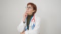 Mature hispanic woman doctor standing with doubt expression thinking over isolated white background Royalty Free Stock Photo