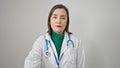 Mature hispanic woman with grey hair doctor standing with serious expression over isolated white background Royalty Free Stock Photo