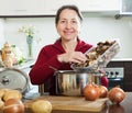 Mature housewife with dried mushrooms Royalty Free Stock Photo