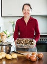 Mature housewife holding dried mushrooms Royalty Free Stock Photo