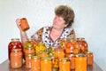 Mature housewife with home canned vegetables