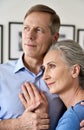 Mature husband embracing smiling middle aged wife, dreaming of good future. Royalty Free Stock Photo