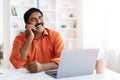 Mature indian man talking on mobile phone, working from home Royalty Free Stock Photo