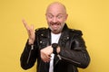 Mature italian man in black leather jacket impatiently pointing to his watch Royalty Free Stock Photo