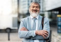 Mature Japanese businessman, arms crossed or city travel by office building street or public transport station. Portrait Royalty Free Stock Photo