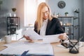 Mature lady doing paper work at modern office