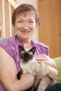 Mature lady holding kitten