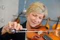 Mature lady playing violin Royalty Free Stock Photo