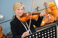 Mature lady playing violin Royalty Free Stock Photo