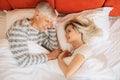 Mature love couple looks at each other in bedroom Royalty Free Stock Photo