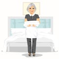 Mature maid woman with towels and bed sheets. House cleaning service concept Royalty Free Stock Photo