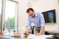 Mature male architect working on laptop on building project drawing sketch in office studio workspace Royalty Free Stock Photo