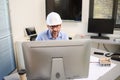 Mature male architect working on laptop on building project drawing sketch in office studio workspace Royalty Free Stock Photo