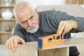 mature male checking wood level Royalty Free Stock Photo