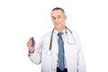 Mature male doctor holding a thermometer Royalty Free Stock Photo