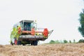 Mature male farmer driving harvester in field Royalty Free Stock Photo