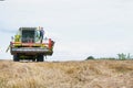 Mature male farmer standing on harvester in field Royalty Free Stock Photo