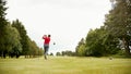 Mature Male Golfer Hitting Tee Shot Along Fairway With Driver