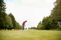 Mature Male Golfer Preparing To Hit Tee Shot Along Fairway With Driver Royalty Free Stock Photo