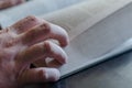 Mature male hand from above on an open book Royalty Free Stock Photo