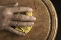 Mature male hand wipes the cutting board with kitchen rag