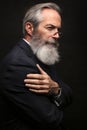 Mature male model wearing suit with grey hairstyle and beard Royalty Free Stock Photo