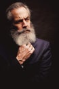 Mature male model wearing suit with grey hairstyle and beard Royalty Free Stock Photo