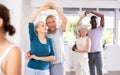 Mature male novice student of fitness studio practices paired Latin American rumba dance Royalty Free Stock Photo