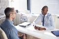 Mature Male Patient In Consultation With Doctor In Office Royalty Free Stock Photo