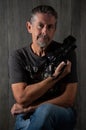 Mature male photographer portrait with DSLR camera