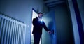 Mature Male Security Guard With Flashlight Standing In Corridor Royalty Free Stock Photo