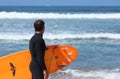 Mature male surfer looks at waves Royalty Free Stock Photo