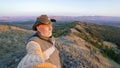 Mature male tourist stands on the top of Akbura mountain and enjoys the beautiful view of the Ural mountains