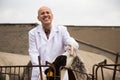 Mature Male vet employee with dairy cattle in livestock farm Royalty Free Stock Photo