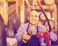 Mature male wine maker corking bottle of wine Royalty Free Stock Photo