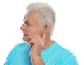 Mature man adjusting hearing aid Royalty Free Stock Photo