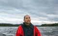 Mature Man Against A Overcast Landscape With A Lake Royalty Free Stock Photo