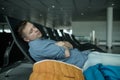 Mature man in airport sleeping on a bench Royalty Free Stock Photo